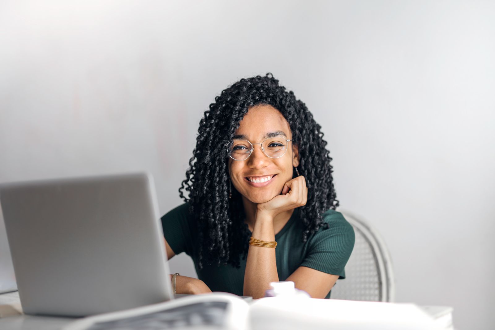 A freelancer smiling at her laptop